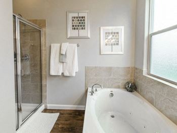 Separate stand-up showers with rainwater showerheads & upgraded plumbing fixtures